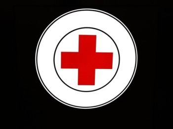 Featured is a photo representation of the Red Cross "First Aid" symbol.